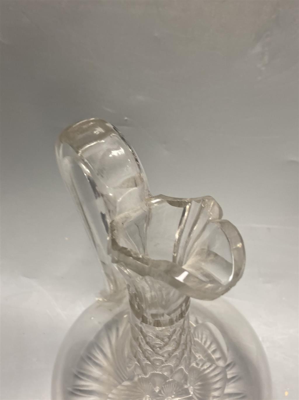 A pair of early 19th century cut glass decanters, height 24cm and an Edwardian claret jug, height 30cm (one decanter a.f.)